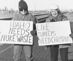 Protest in the 80s, sign reads Idaho-Needs-Nuke-Waste-Like-Turkeys-Need-Christmas.